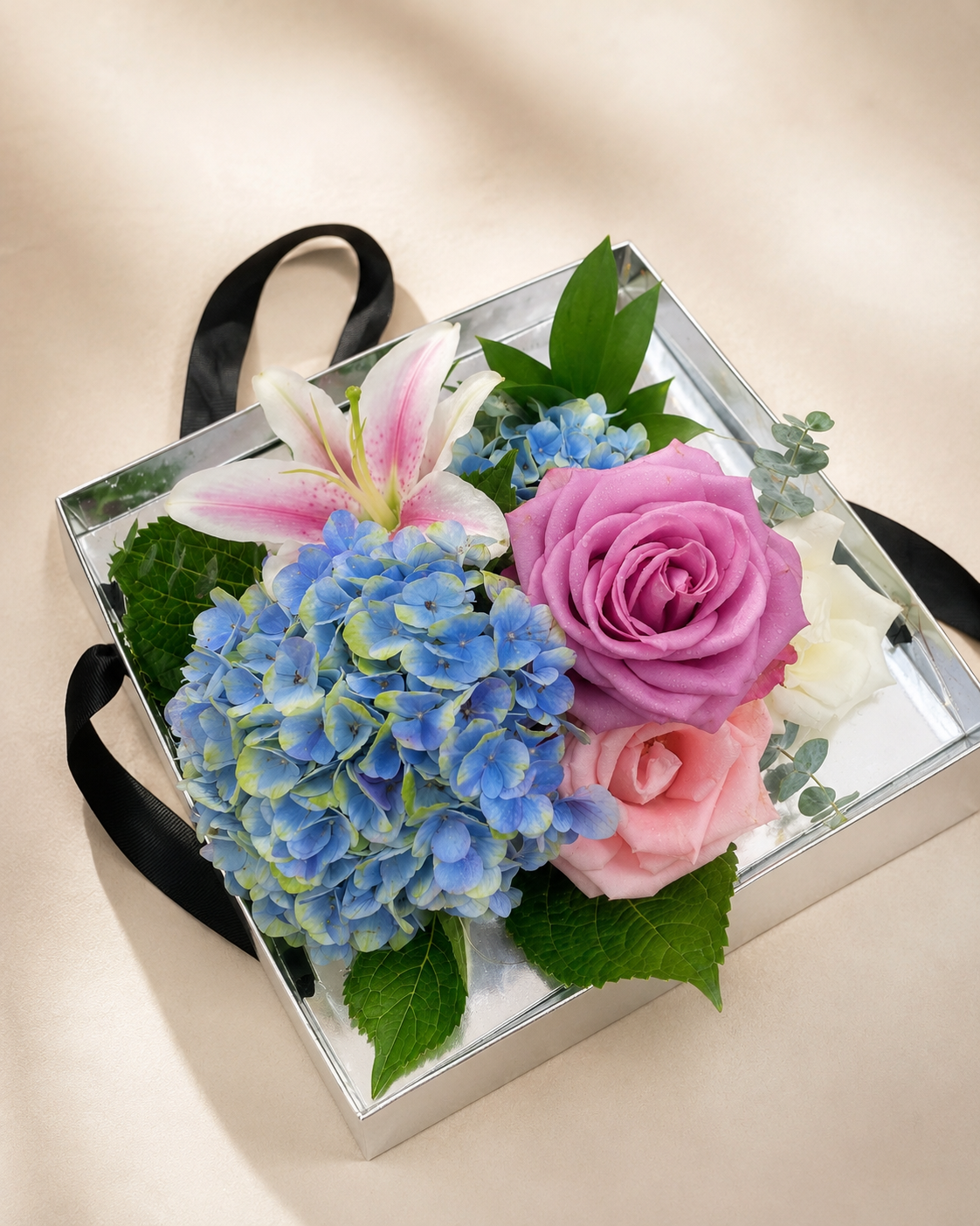 Pastel flower box with blue hydrangea, pink roses and lilies