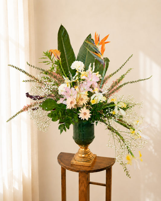 Contemporary corporate floral arrangement with white pink and orange seasonal flowers