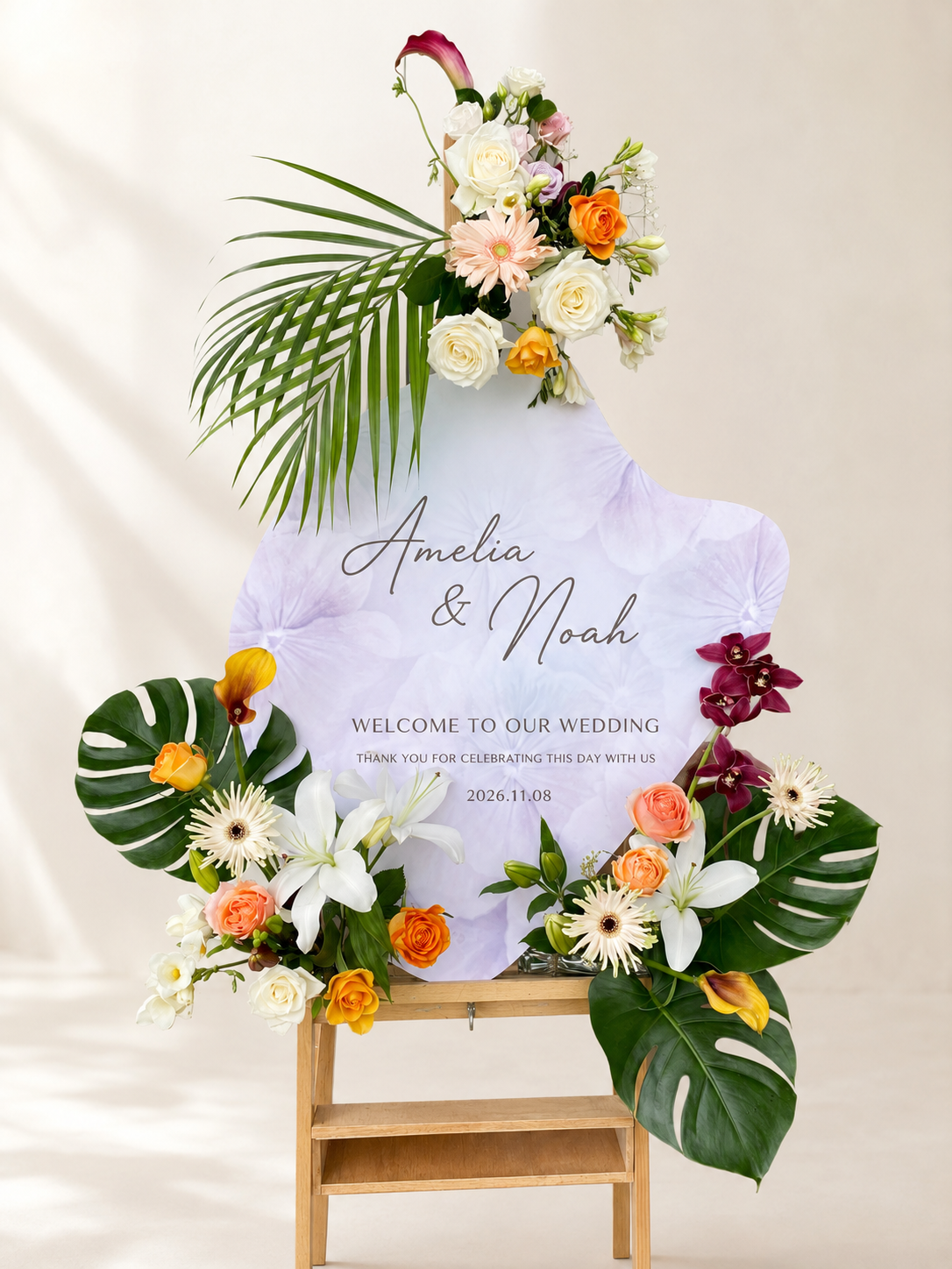 Personalised wedding welcome sign with elegant tropical florals and lush greenery.